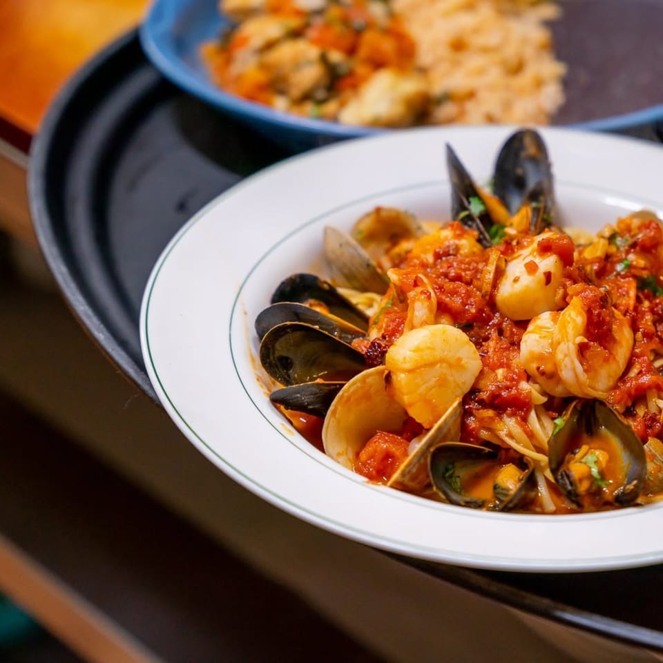 Seafood pasta with mussels, clams, shrimp, and scallops in a rich red sauce.